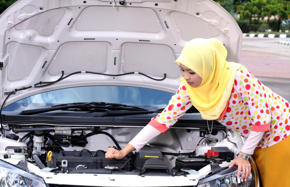 Lady checking under the bonnet